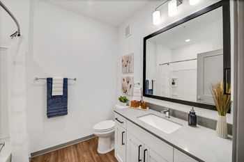 A bathroom with a large mirror and a toilet and sink